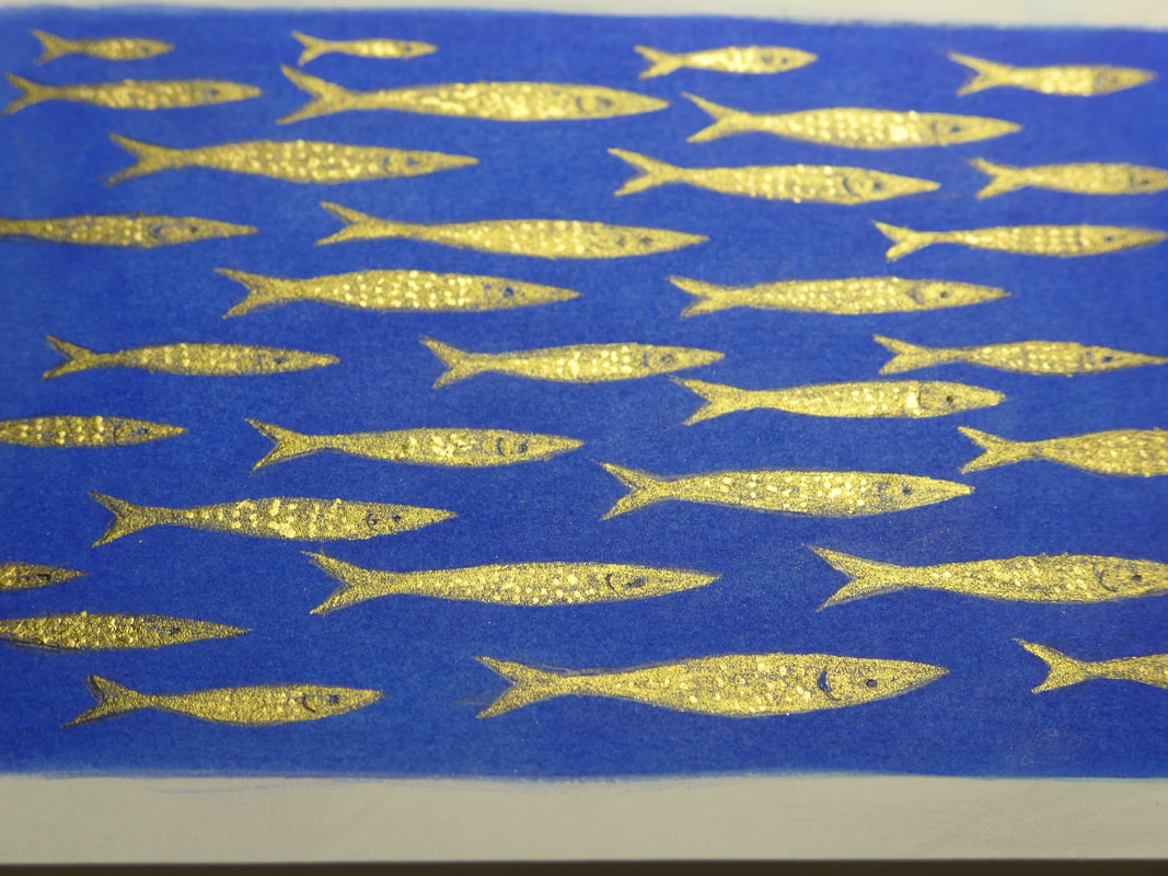 Gold and ultramarine blue painting of shoal of fish by artist diane young